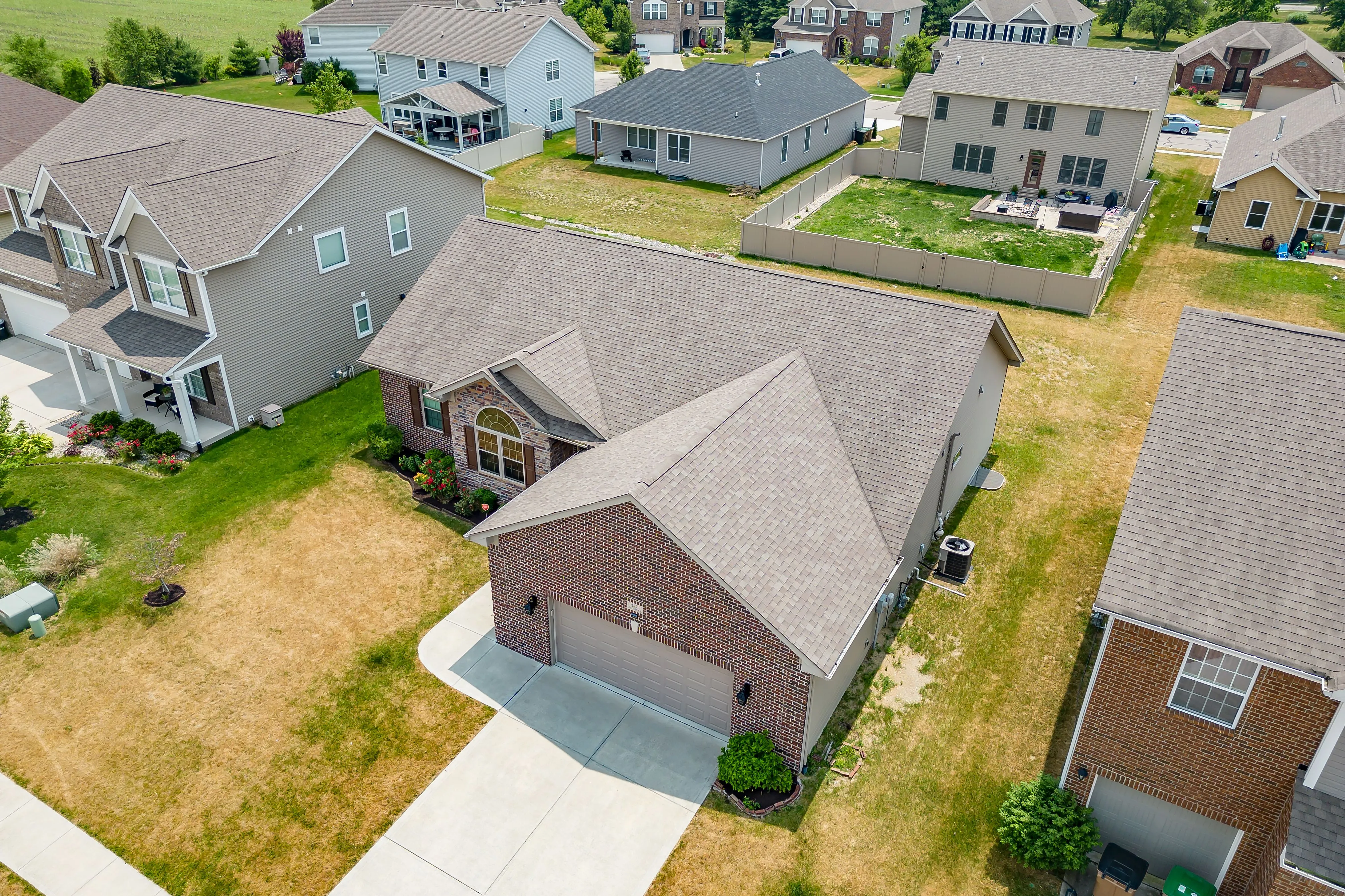 Aerial view of a suburban neighborhood with houses and green lawns.