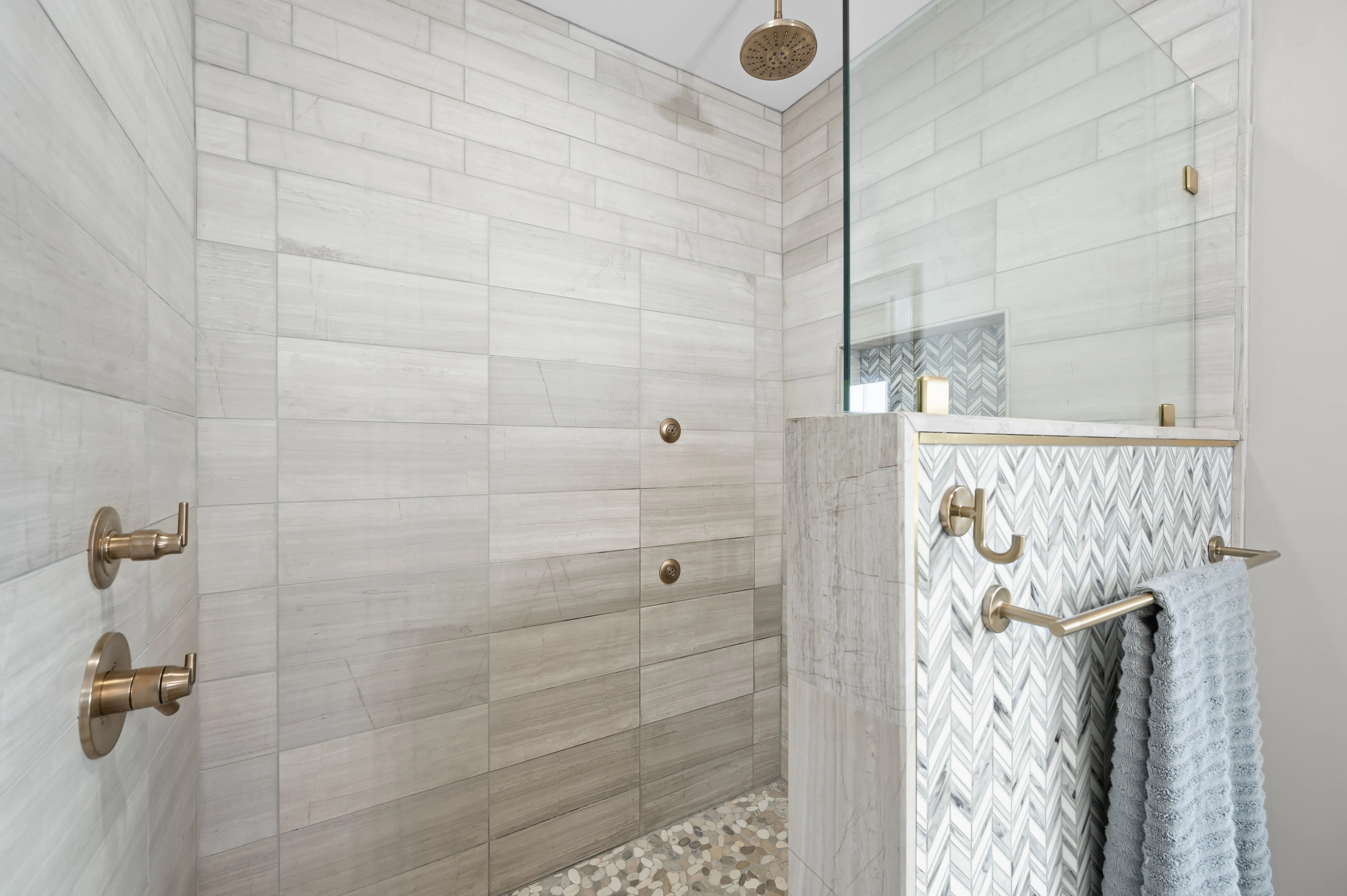 Modern bathroom with glass shower enclosure and white subway tiles.