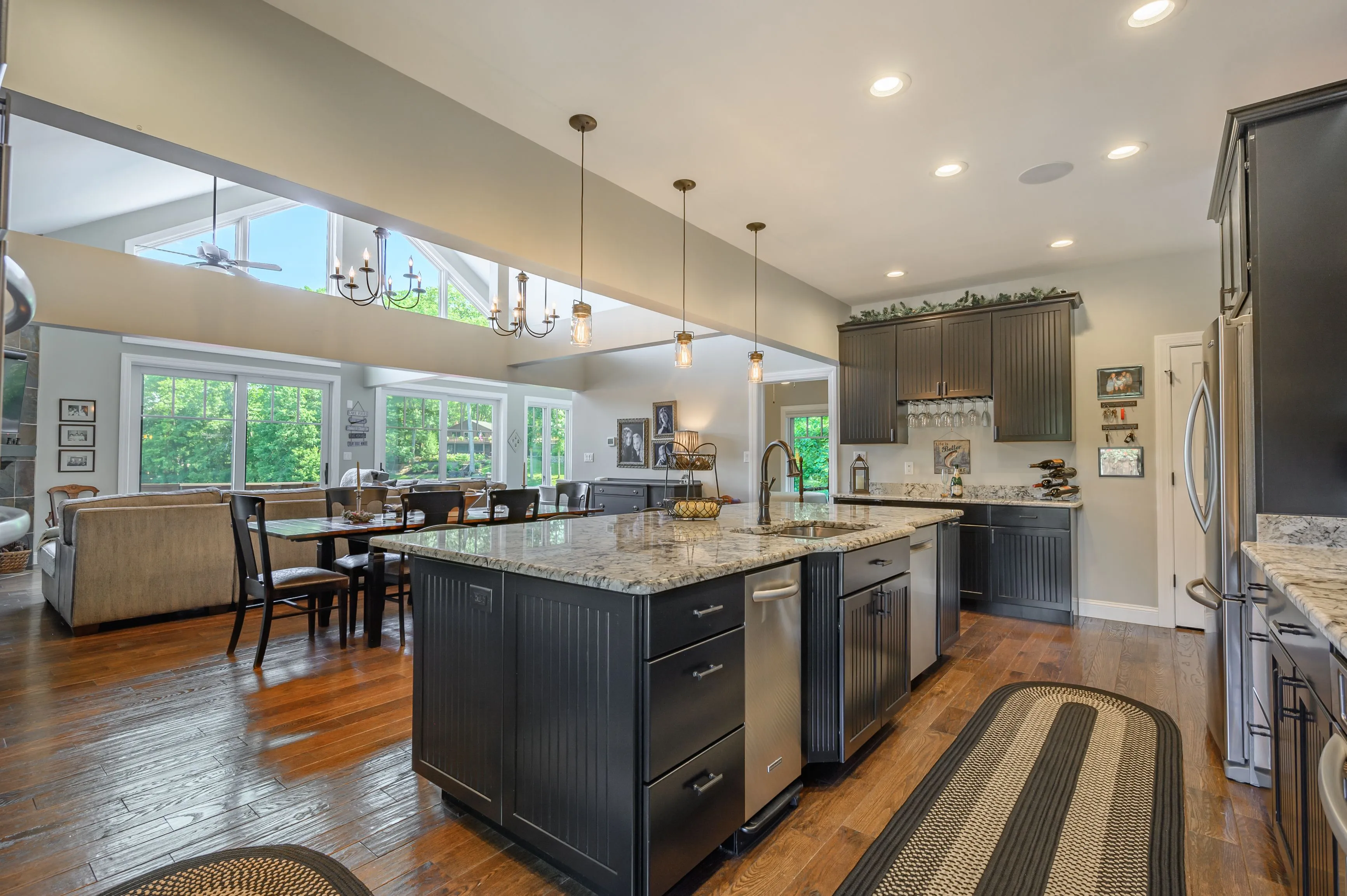 Spacious modern kitchen with center island, hardwood floors, and adjacent dining area.