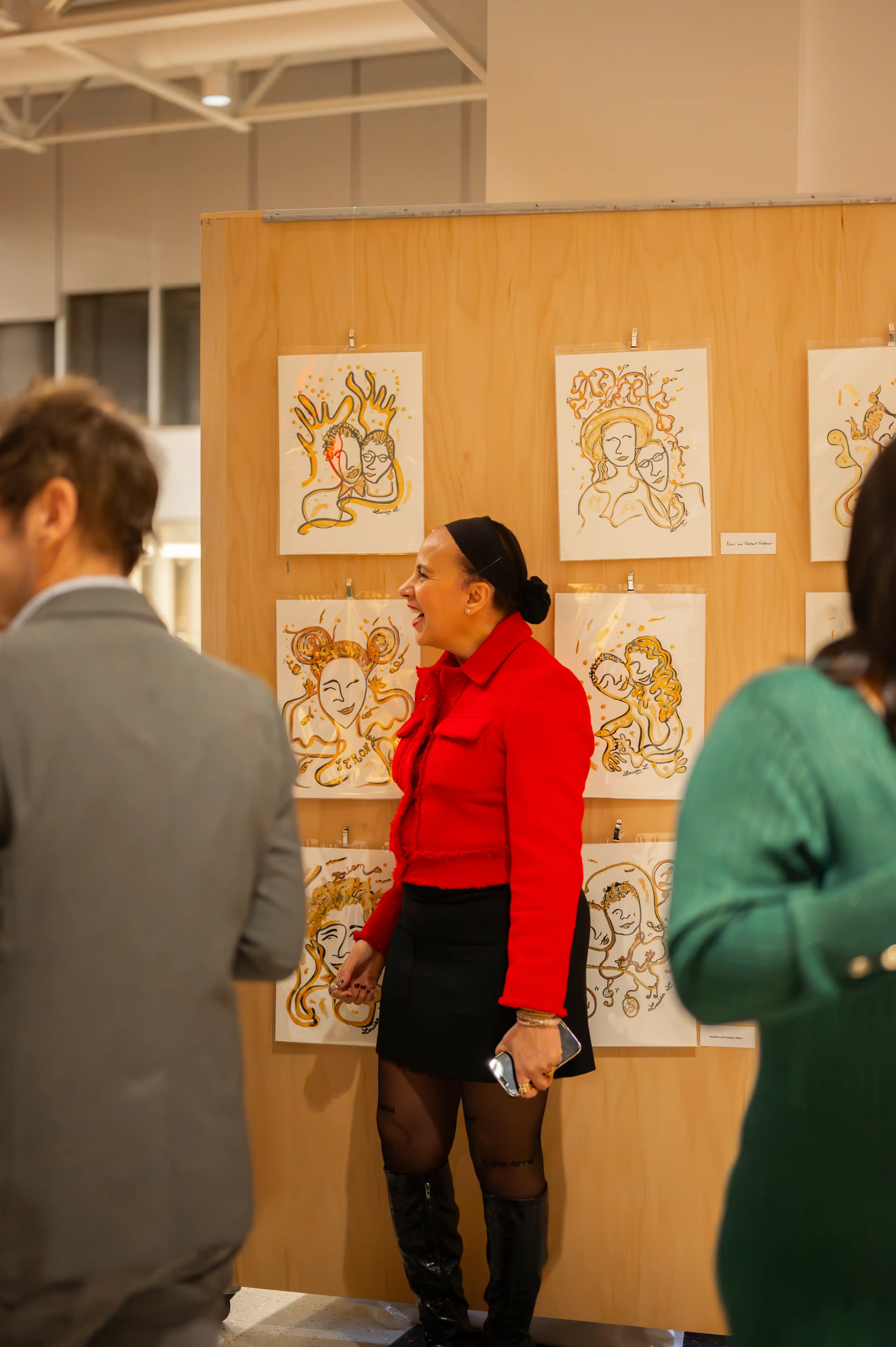 Visitors viewing artwork at an exhibition gallery.