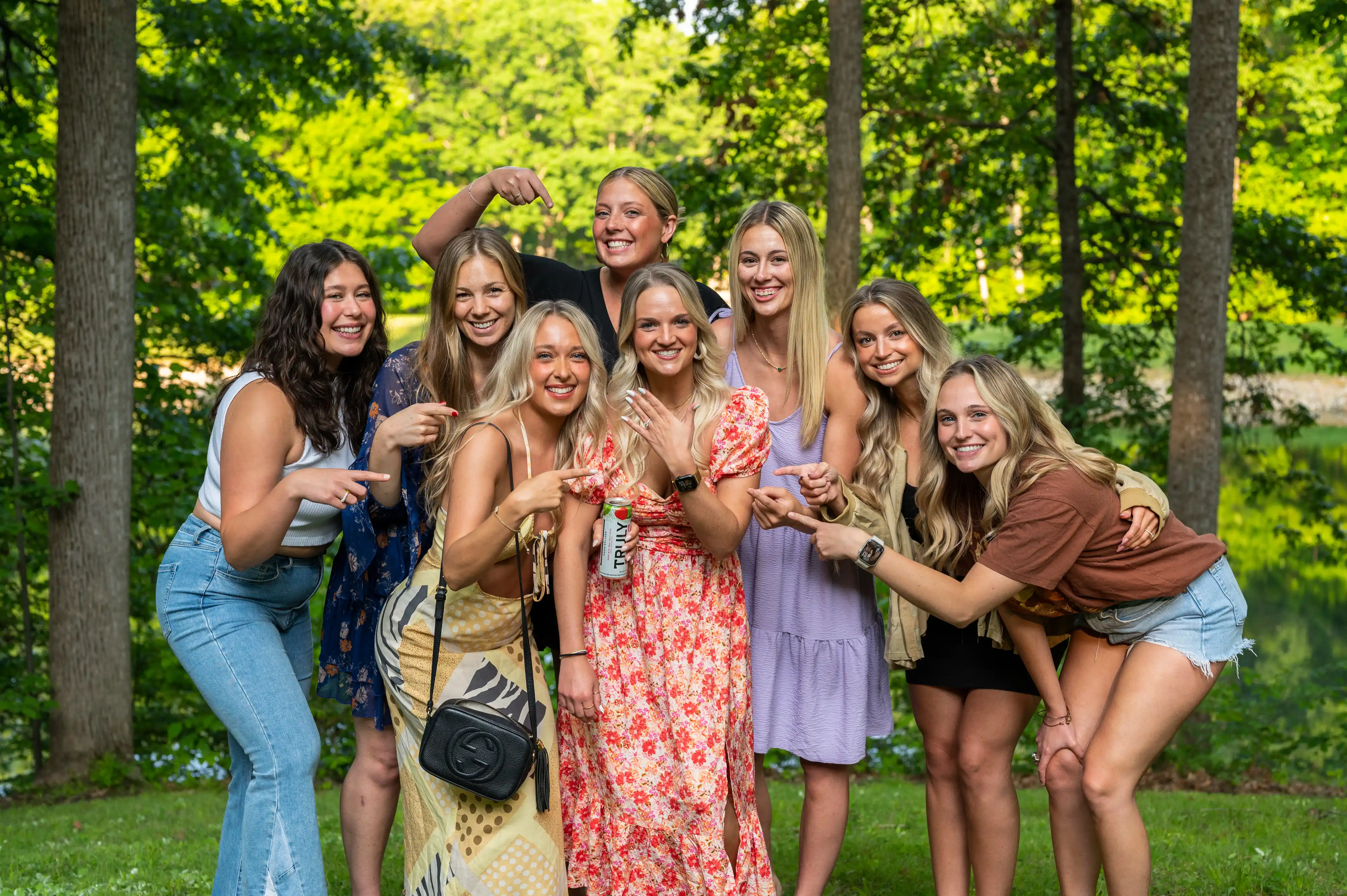Group of happy women smiling and posing together outdoors.