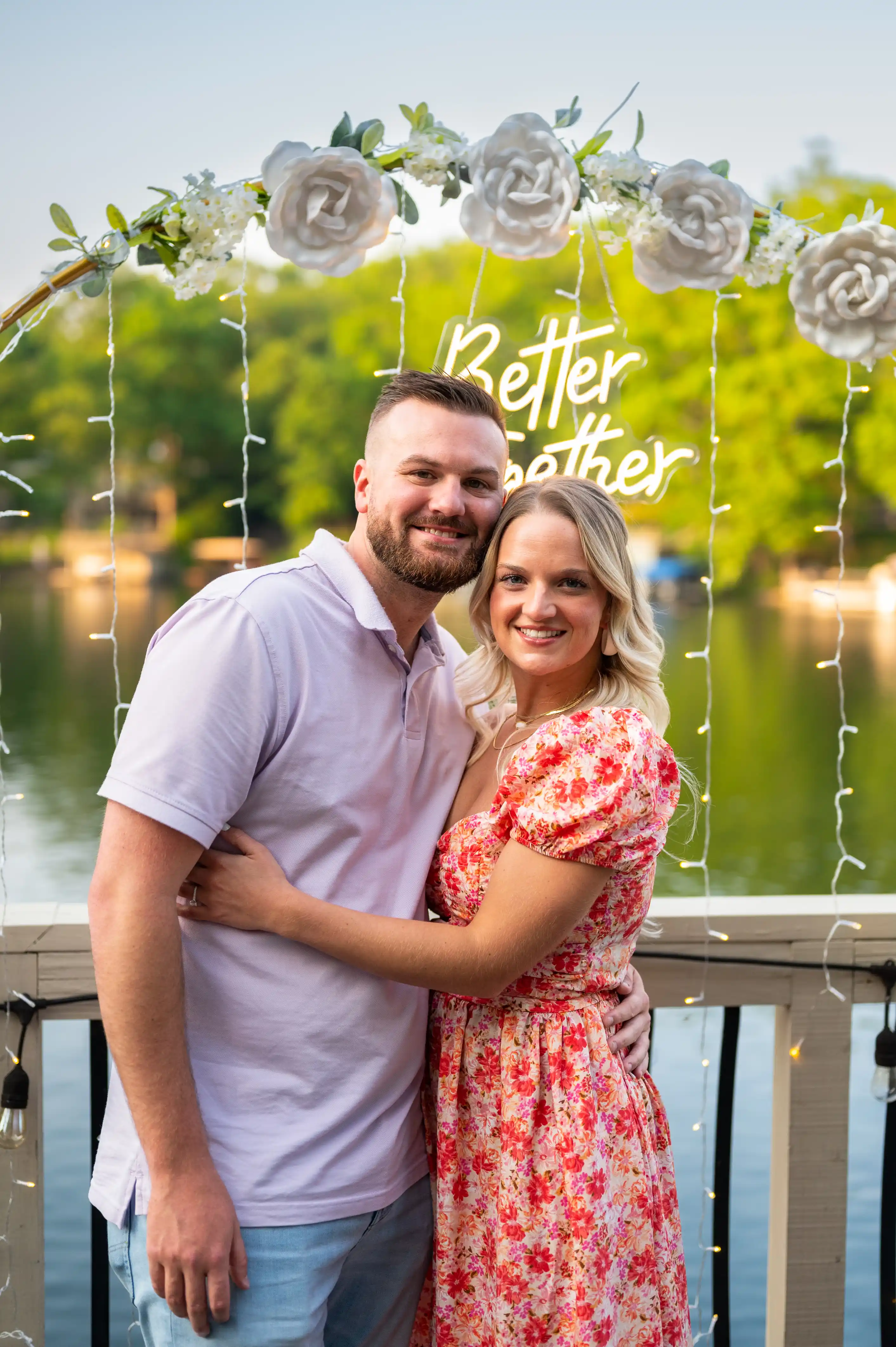 A smiling couple embracing on a lakeside dock with the phrase "Better Together" floating above them.