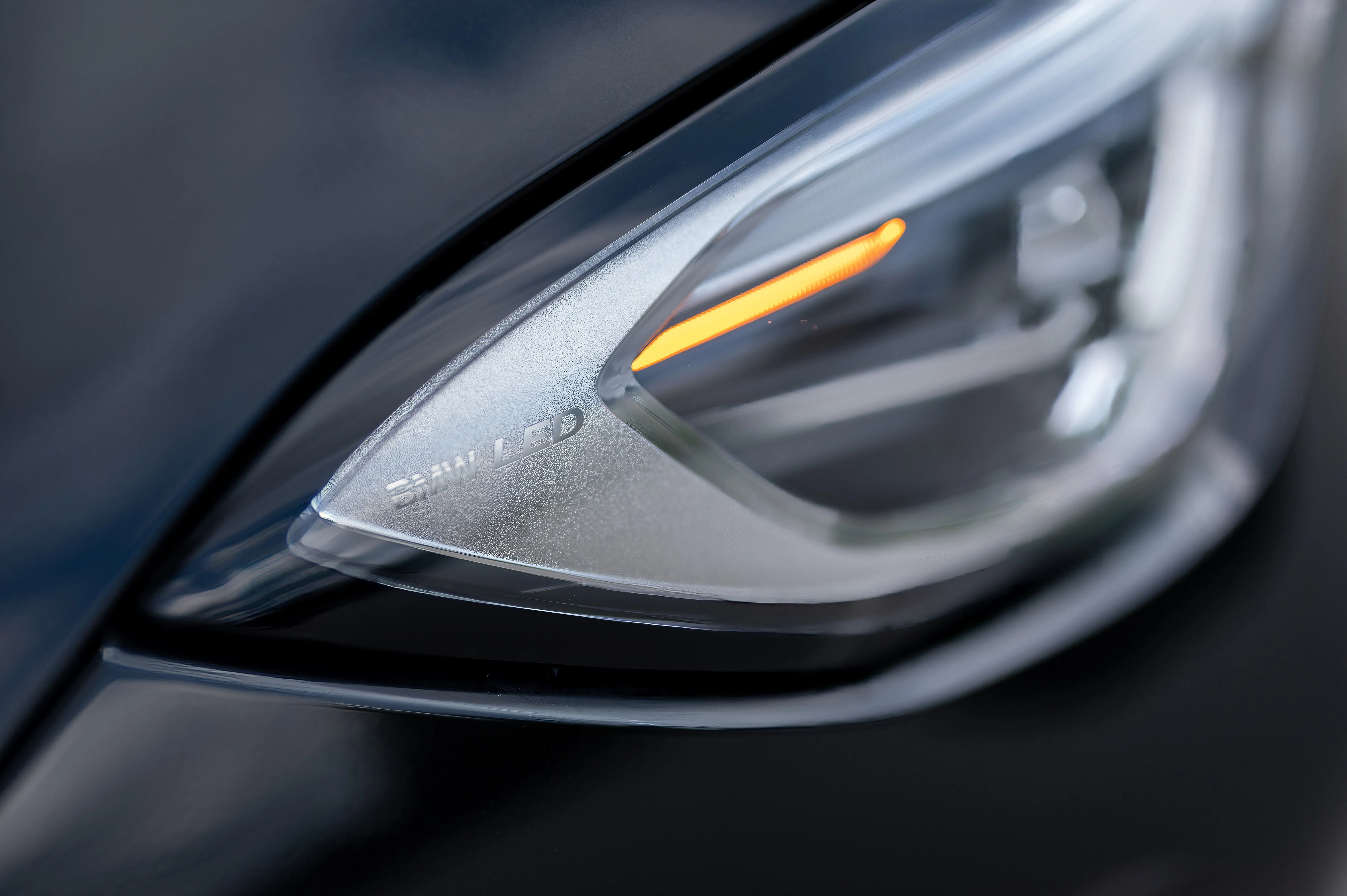Close-up of a modern car's headlight with LED daytime running lights.