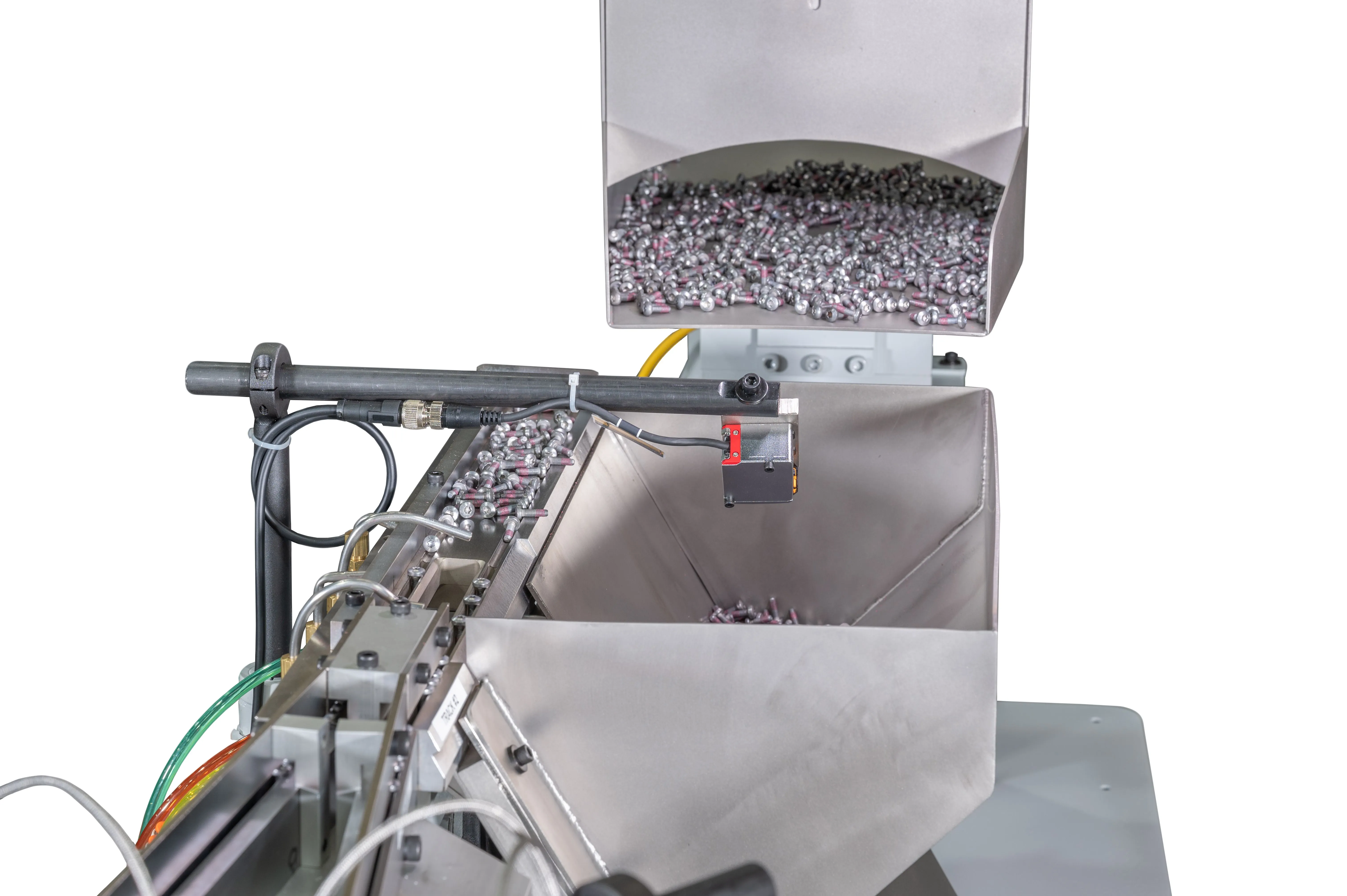 Industrial capsule sorting and counting machine processing pharmaceutical capsules.