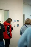 People viewing artwork in a gallery setting.