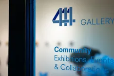Glass door with "4H GALLERY" and "Community Exhibitions, Events & Collaborations" text, hinting at artistic or cultural space.