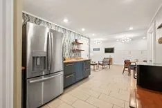 Modern kitchen interior with stainless steel appliances and a bar counter.