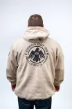 Rear view of a person wearing a beige hoodie with a graphic that reads "FREEDOM ISN'T FREE - AAFC - UNITED STATES OF AMERICA" surrounding an eagle design.