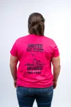 Rear view of a person wearing a vibrant pink T-shirt with the text "UNITED WE STAND DIVIDED WE FALL" and a graphic below the text on a light background.