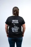 Person from behind wearing a black t-shirt with the text "UNITED WE STAND DIVIDED WE FALL" printed on the back.