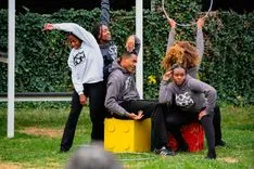 Group of people enjoying an outdoor dance workout session in a park.