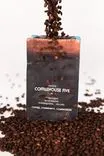 A bag of Coffeehouse Five coffee surrounded by a cascade of coffee beans against a white background.