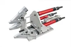 Industrial pneumatic press apparatus with red and silver components on a white background.