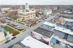 Aerial view of a small town with historic buildings and a courthouse with a dome.